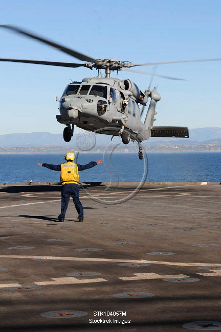 Boatswain S Mate Directs An Mh S Sea Hawk Helicopter On The Flight